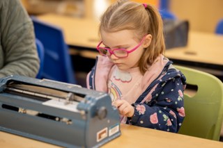 child learning braille