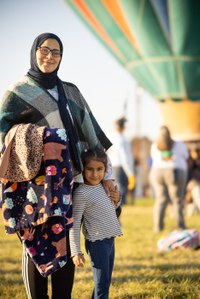 Parent and child in front of balloon