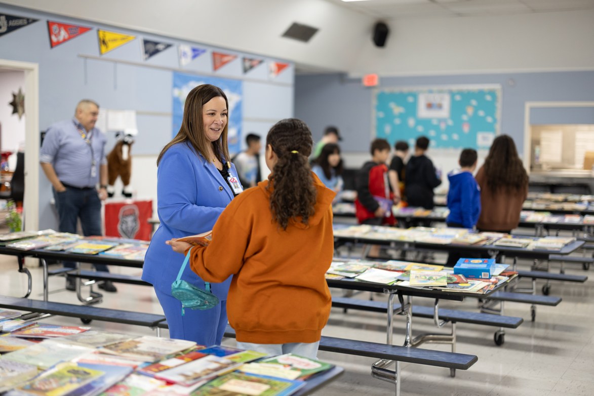 Superintendent Blakey talking to student at a book fair