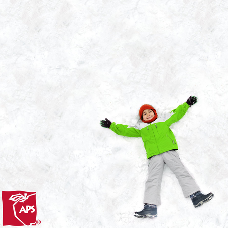 Child laying in the snow.