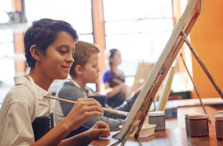student drawing at an easel
