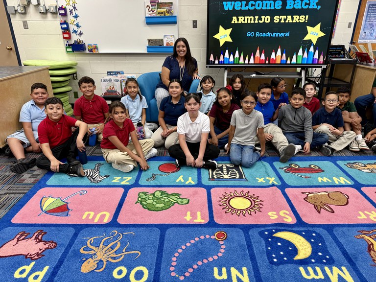 Amy Nims Armijo Elementary School Librarian Amy Nims poses for a photo with one of her classes.