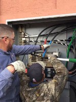 Two M&O employees installing new electrical cabling