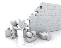 A figure using puzzle pieces to build a wall