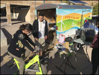 Student generating electricity on stationary bike