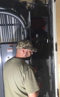 An M&O technician working on an electrical upgrade
