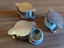 3 metal loupes sitting on table