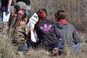 Group of kids and chaperones doing Whitfield Bosque Plant Key activity during program at Whitfield Wildlife Conservation Area in Belen, NM.