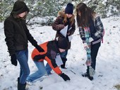 Kids during their Ecology Field Program in the winter with snow all over the ground on Meadow trail.