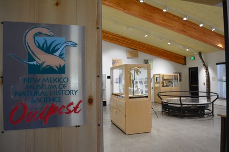 New Mexico Museum of Natural History & Science Outpost sign with view of exhibits in museum
