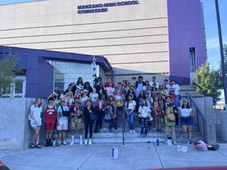 Students in front of Manzano High School gymnasium. 