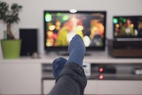 photo of a person sitting with feet up in front of the television. (not always a bad thing!)