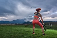 picture of woman in a field with battle ropes. 